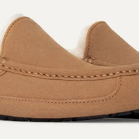 Tan slip-on shoes with white lining on a light gray background