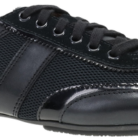 A black low-top lace-up shoe with a mix of smooth leather and mesh textures, shown from a side profile on a white background.