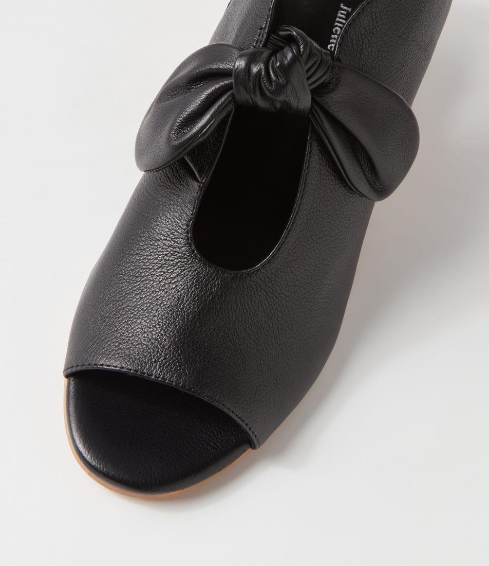 Black open-toe shoe with a bow on a white background