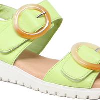 Green sandal with orange buckle on a white background