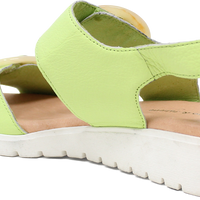 Green sandal with a white sole on a white background
