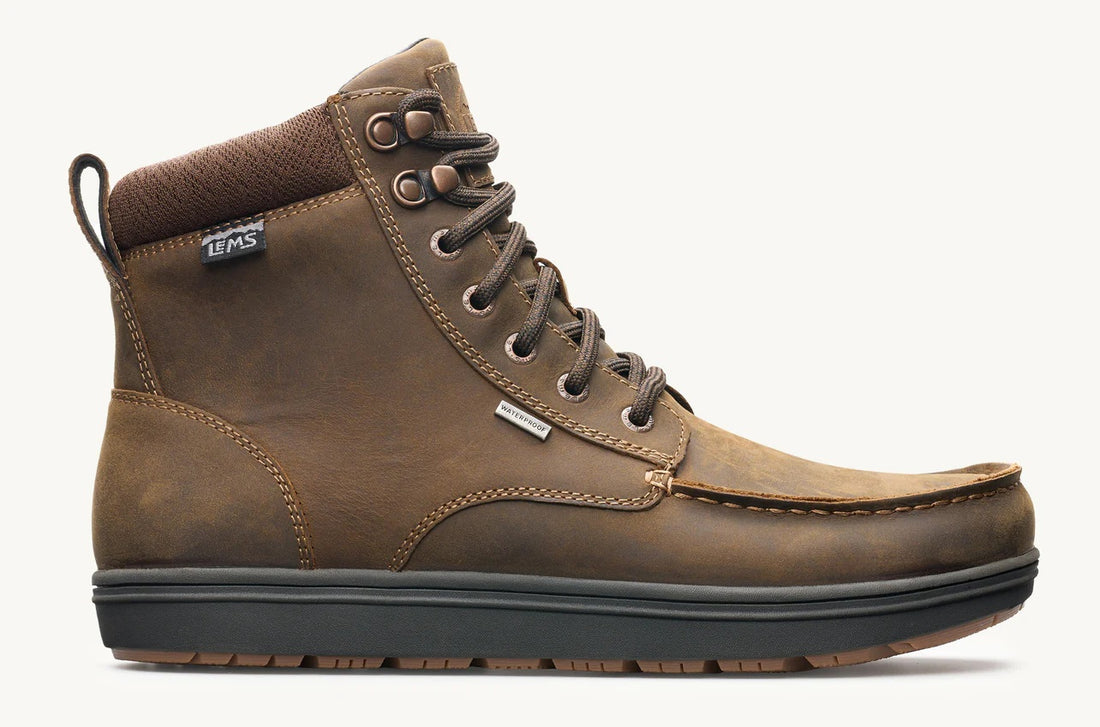 Brown leather boot with black sole on a white background